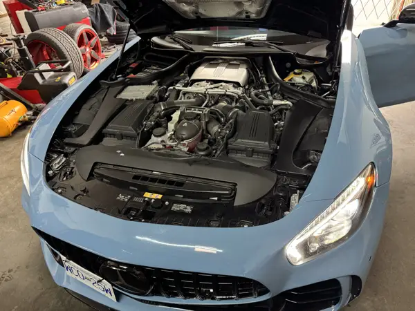 Engine bay inspection · Workshop photograph