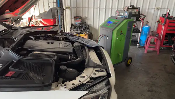 Engine bay inspection · Workshop photograph
