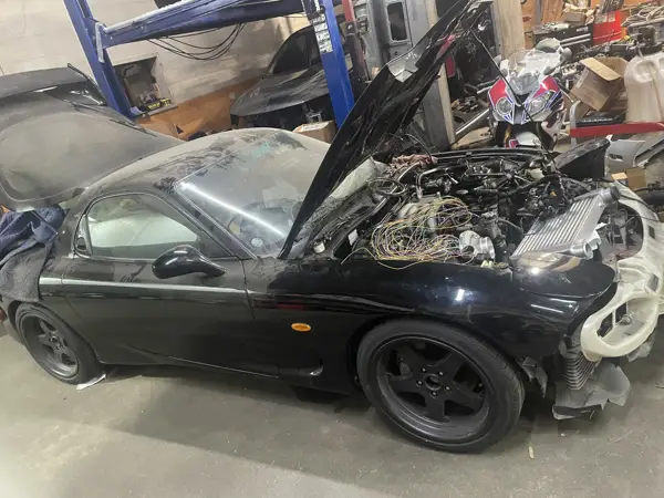 Engine bay inspection · Workshop photograph