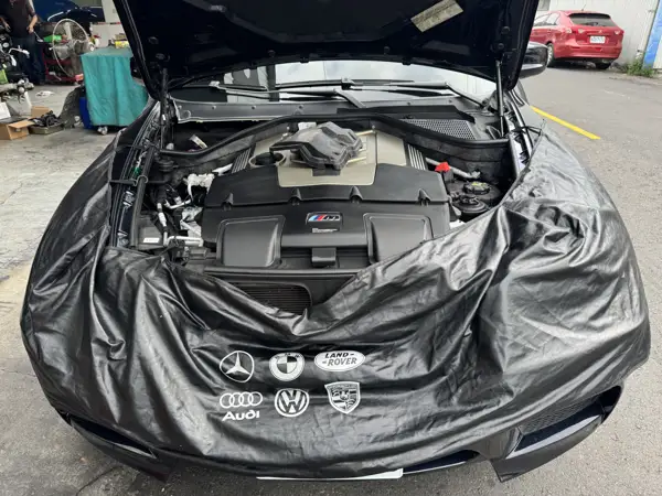 Engine bay inspection · Workshop photograph