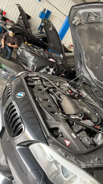 Engine bay inspection · Workshop photograph