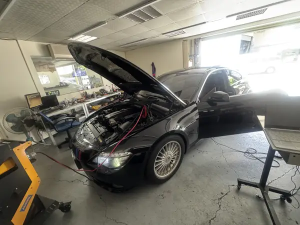 Engine bay inspection · Workshop photograph